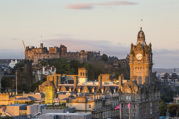 Edinburgh Castle and the Balmoral Hotel clocktower at sunrise