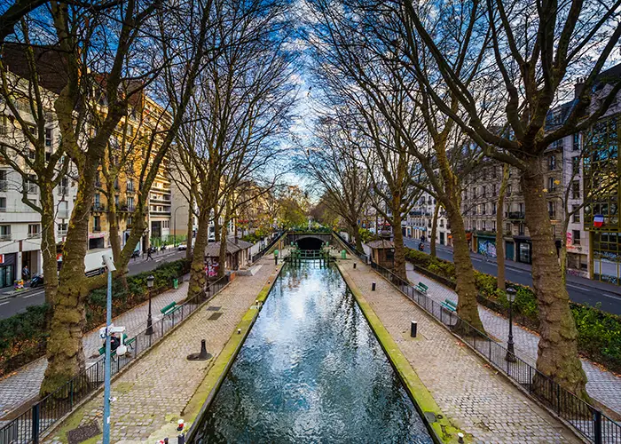 Canal Saint-Martin in Paris, lined with sidewalks and buildings. 
