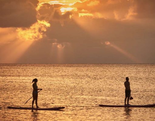 Cayman Islands Tourism Reinvention Plan Announced Paddleboarding at sunset