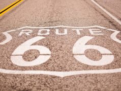 Rerouting Route 66: 7 American Road Trips To Add to Your Bucket List route 66 sign painted on the hyway