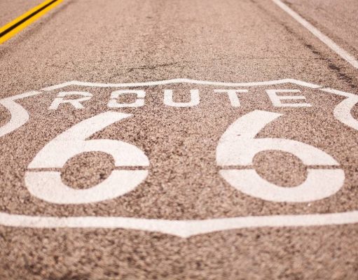 4 things to know before a US road trip route 66 sign painted on the hyway