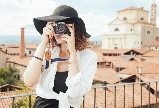 An Ultimate Guide to Write a Tour Guide Resume gril taking oictures while traveling