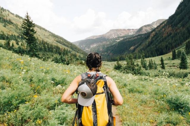 hiker walking trough a valley