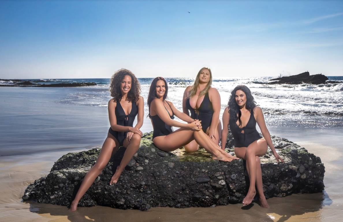 girls sitting on a rock at the beach