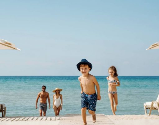 Sani Resort redesigns Luxury Family vacations to include Great Outdoors kids playing on a beach in greece