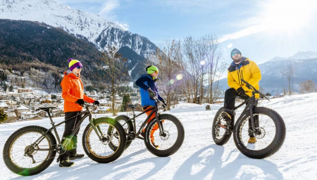a group of people riding on fat tire bikes