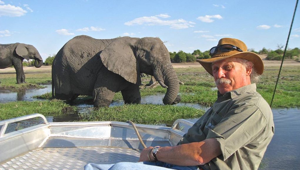 man on safari viewing elephants