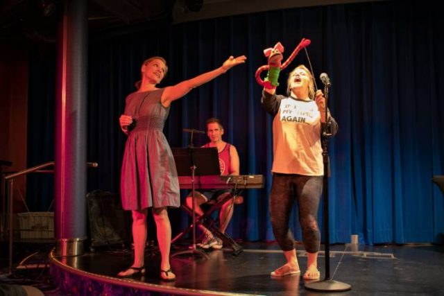 actors on stage on a cruise ship