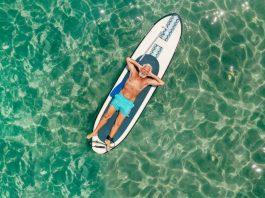 boomer man floating on a paddle board