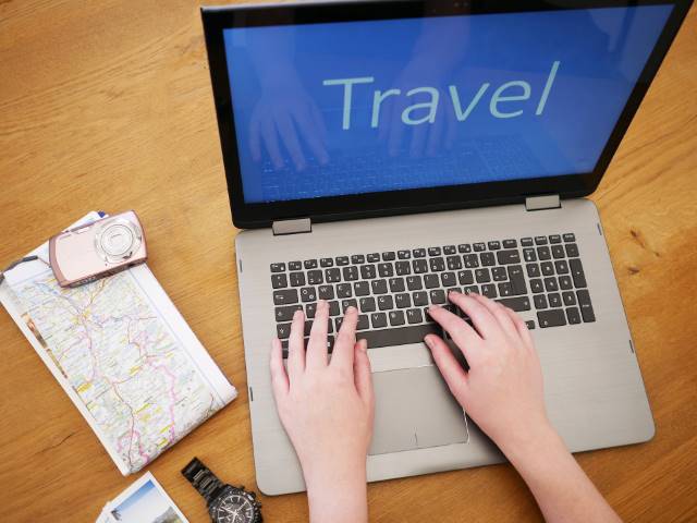 booking travel online with a laptop