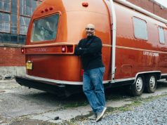 How to Set Up a Toilet in Your RV man standing beside his RV trailer