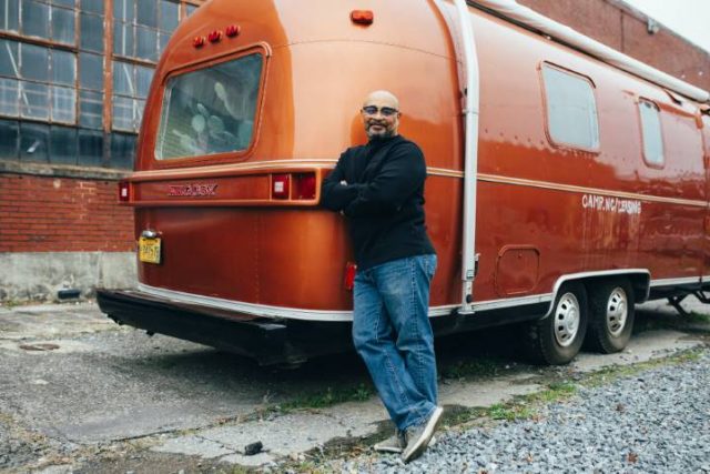 pexels-photo-2182980 man standing beside his RV trailer