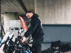 How To Safely Move Your Beloved Two-wheeler Across Country person getting his motorcycle ready for a cross country trip