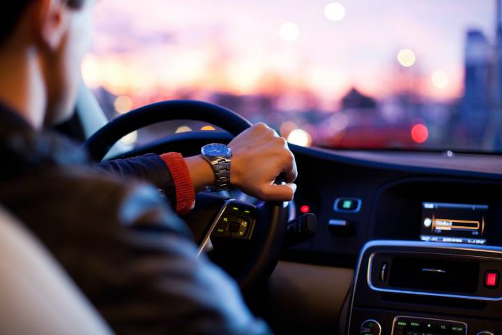 man driving a car in heavy traffic