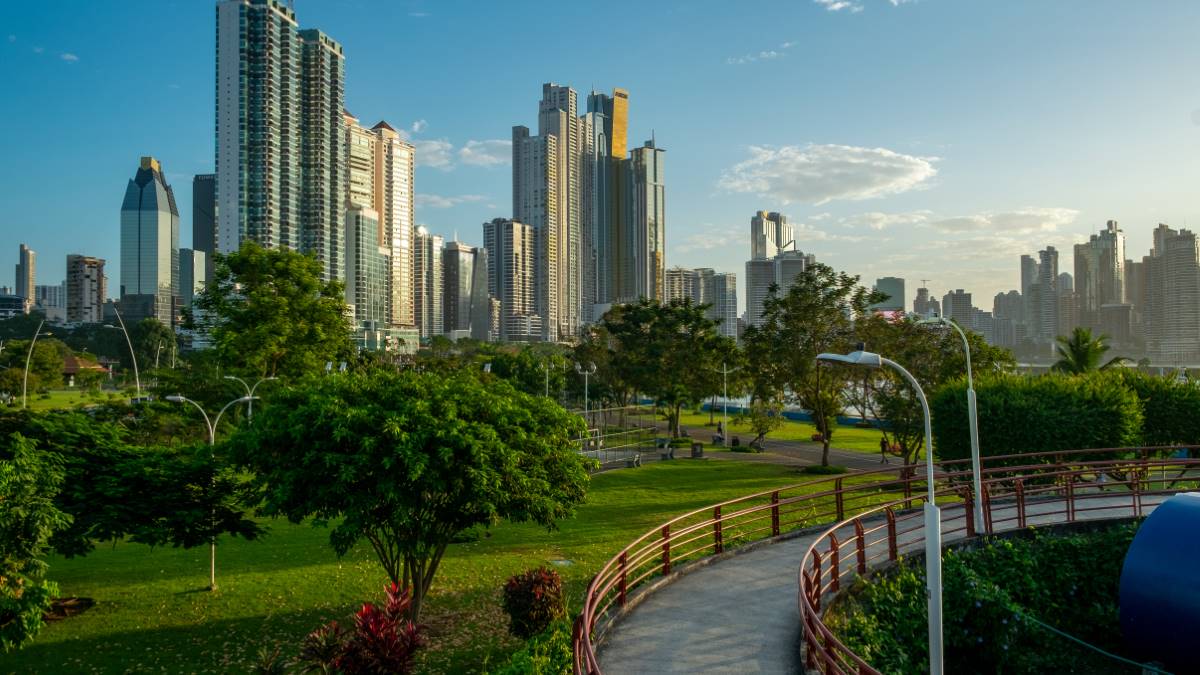 Pedestrian overpassin the Cinta Costera/ walkway with city skyline background and palm trees , Panama City , Central America