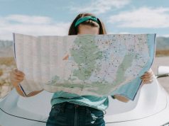 6 Amazing Gifts For Travel Lovers gorl traveling and reading a raod map