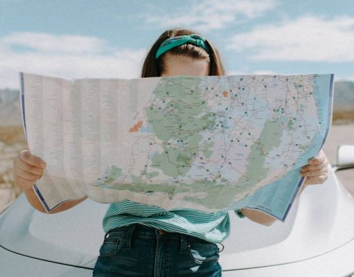 6 Amazing Gifts For Travel Lovers gorl traveling and reading a raod map
