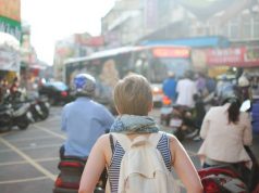 10 Essential Items for Every Trip Woman Traveler Tourist Backpack People City