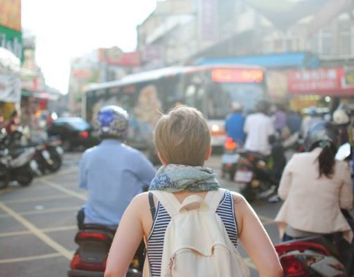 10 Essential Items for Every Trip Woman Traveler Tourist Backpack People City