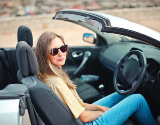 9 Best Accessories To Customize Your Car Before a Trip girl in a convertible car