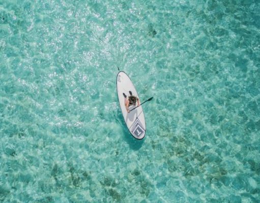 Why You Should Try Paddle Boarding At Least Once In Your Lifetime person on a stand up paddle board