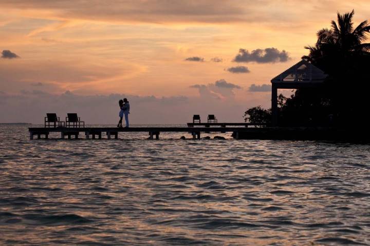 couple on a dock at sunset in Belize