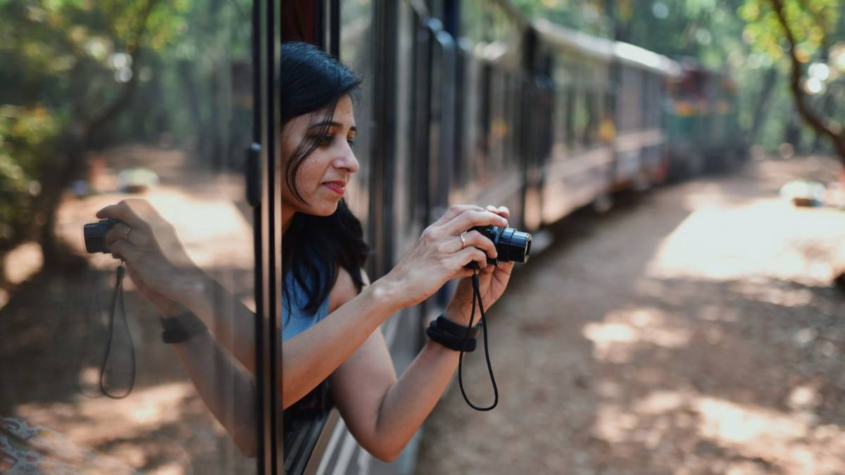 girl taking a photo from a train window