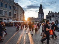 Family Trip to Europe: Travel Safely with your loved ones Tourists on Main Market Square in Krakow, Poland.