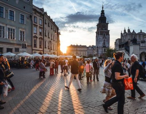 Family Trip to Europe: Travel Safely with your loved ones Tourists on Main Market Square in Krakow, Poland.