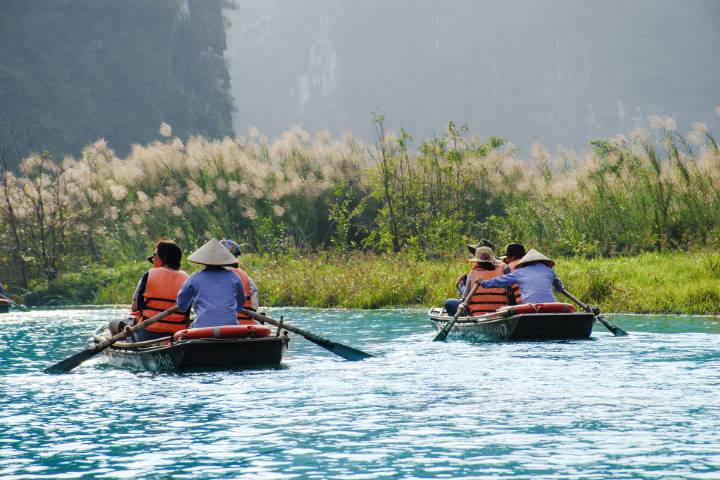 people on a lake in a small boat