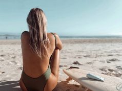 Choosing A Natural Ocean & Reef Safe Sun Cream girl sunbathing on a beach