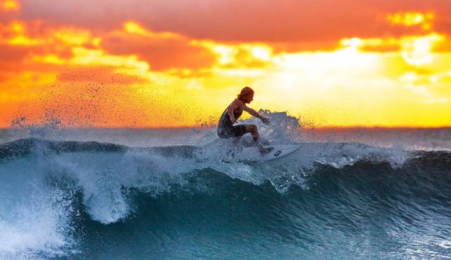 surfing at sunset