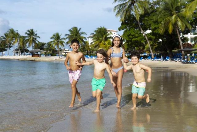 kids running on a beach in St Lucia