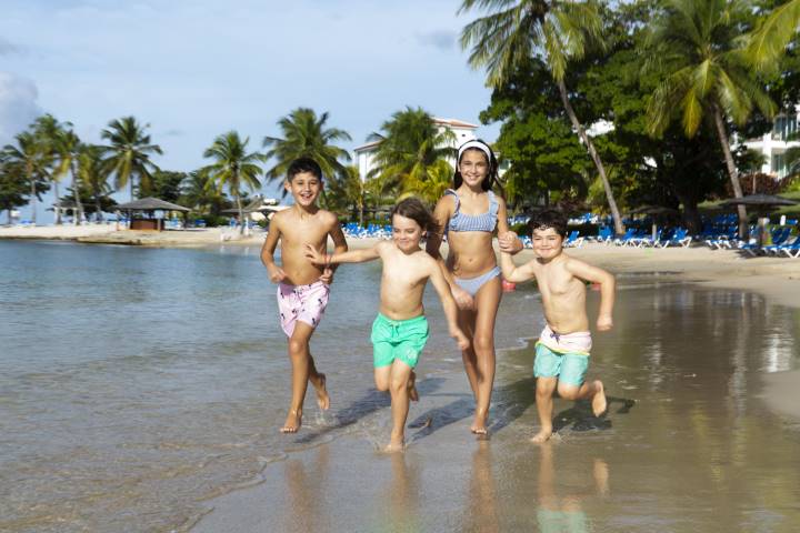 kids running on a beach in St Lucia