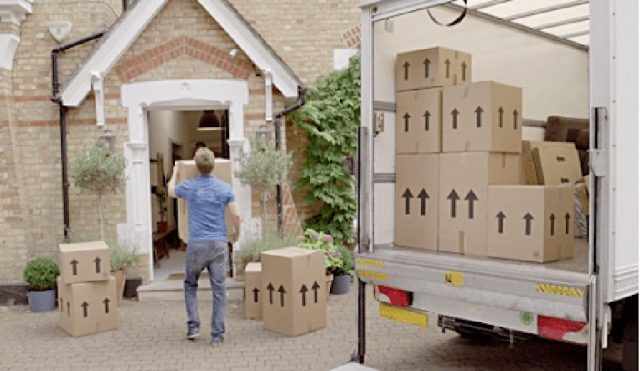 man moving packing boxes