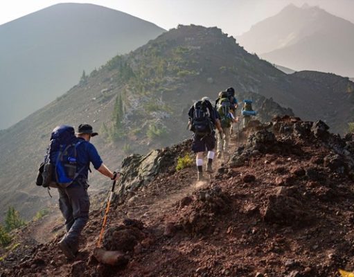 Top 7 Reasons to Consider A Mountain Adventure Trip This Year hiking on a mountain side
