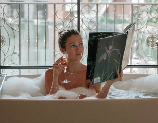 Say Goodbye to Summer with a trip to Spa Relais girl in a bubble bath reading a book