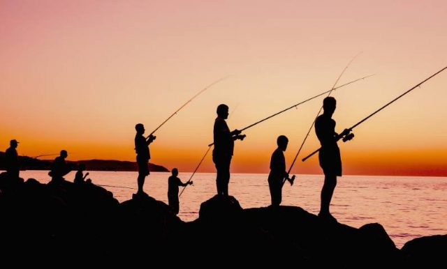 people fishing at sunset