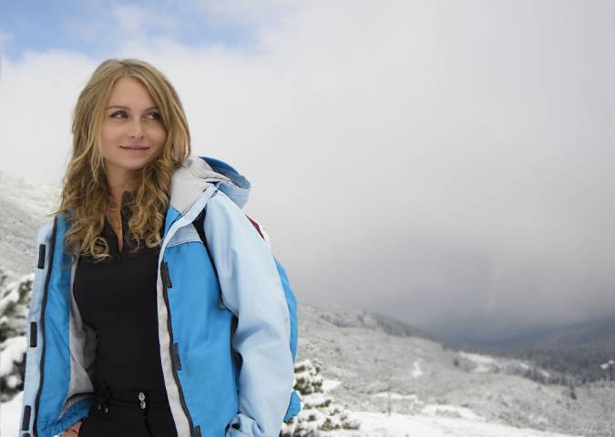 girl in winter with a blue ski jacket