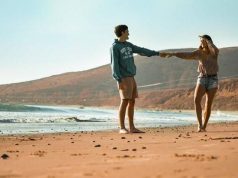 6 Reasons To Go On a Vacation With Your Significant Other couple walking on the beach holding hands
