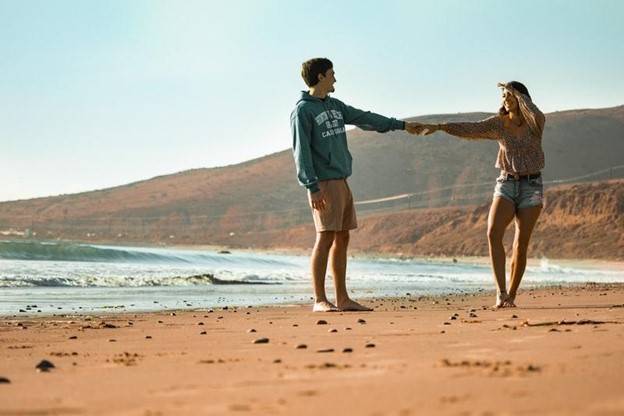 couple walking on the beach holding hands