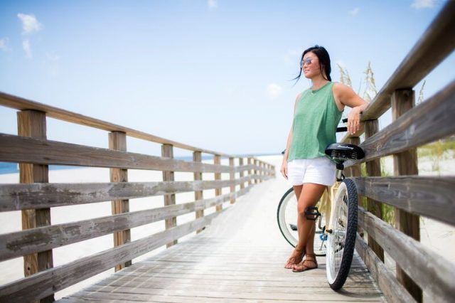 girl with a bicycle on a boardwalk in Alabama
