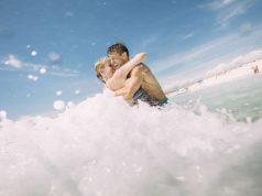 Romantic Valentine’s Day Getaway Spend it in Panama City Beach couple in the water at Panama City Beach