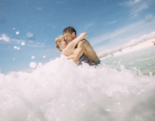 Romantic Valentine’s Day Getaway Spend it in Panama City Beach couple in the water at Panama City Beach