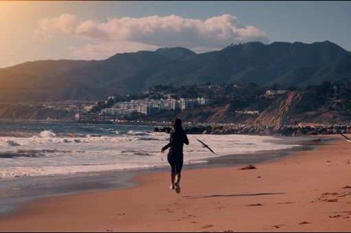 A Los Angeles Adventure Guide girl running on a beach in LA