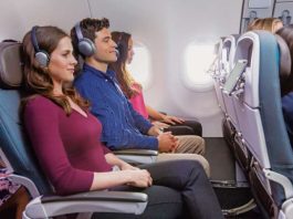 passengers on an airplane with headphones