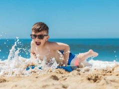 5 Ways to Keep The Kids Safe On The Beach child playing on a beach