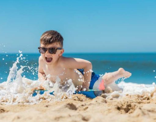 5 Ways to Keep The Kids Safe On The Beach child playing on a beach