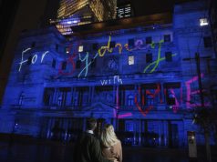 Vivid Sydney Sparkles to Life, Transforming Sydney into a Dazzling Kaleidoscope Of Light Couple viewing the 'For Sydney With Love' projection on Customs House during Vivid Sydney 2022.