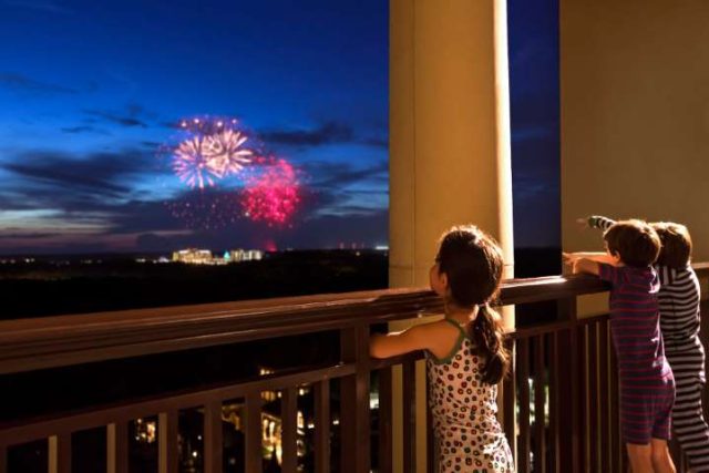 kids watching fireworks from the hotel